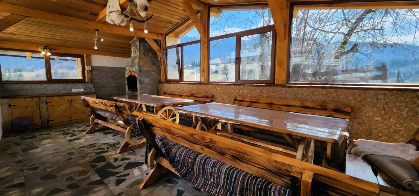 Sala de mese din lemn cu ferestre spre munte